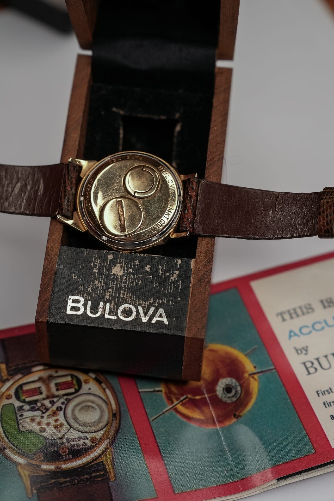 A vintage watch in its original box with brochures