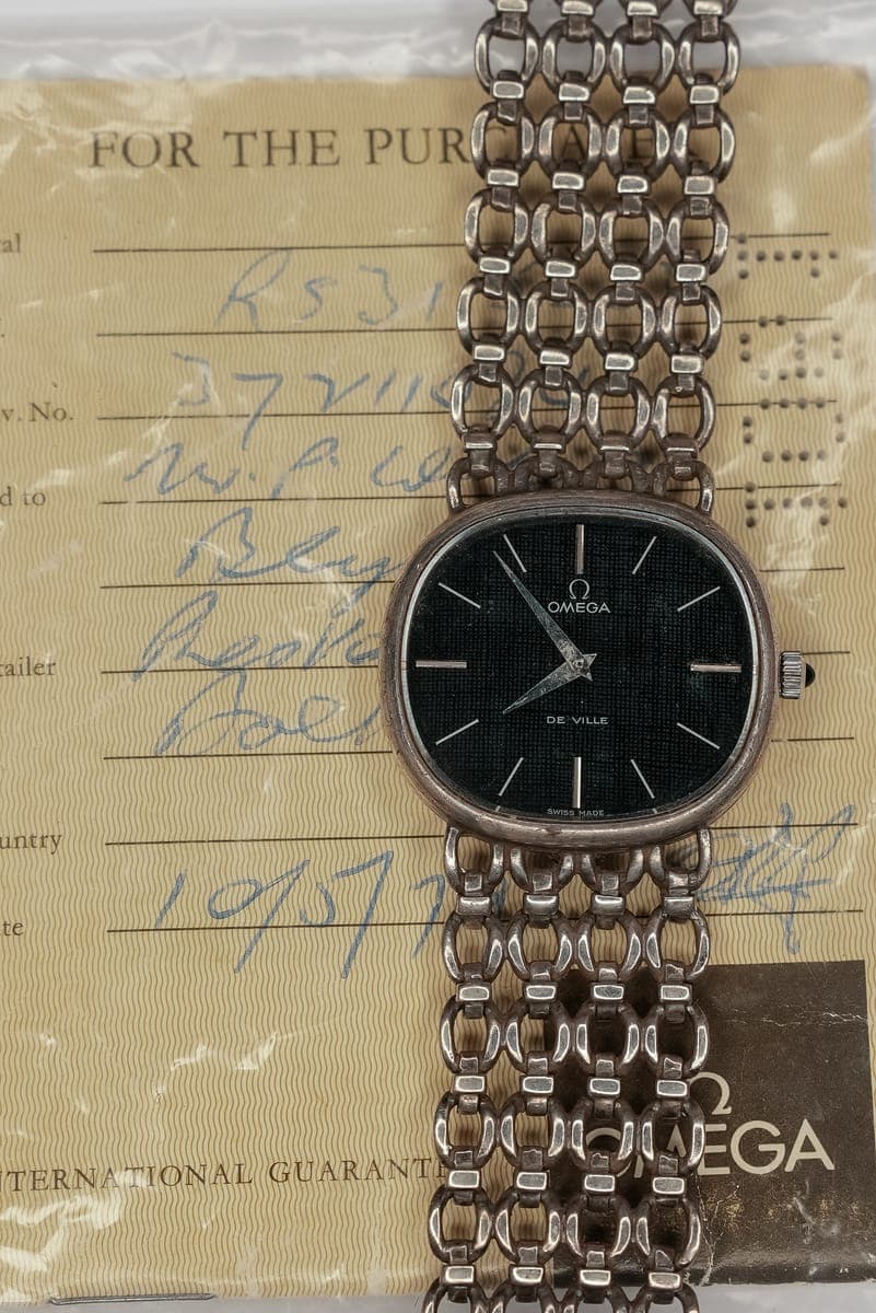 A vintage watch with its original guarantee papers